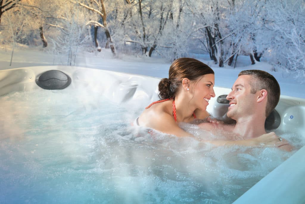 couple in hot tub in the winter couple in hot tub in the winter